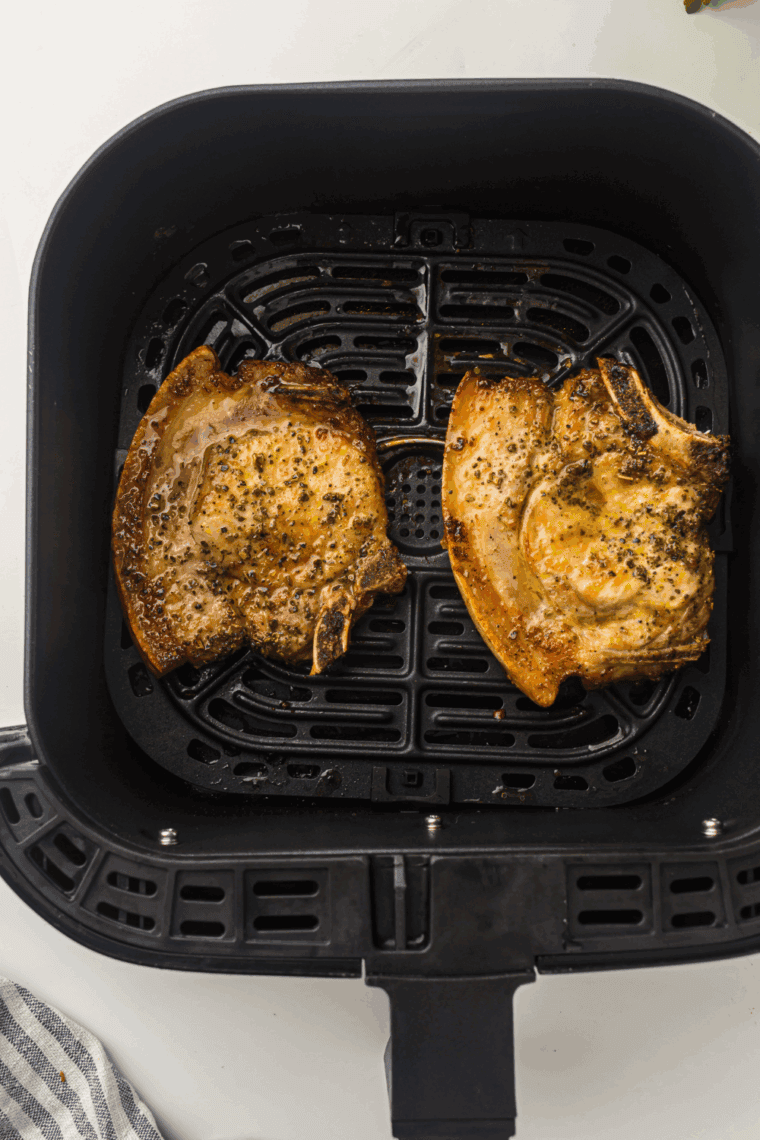 Cooked ranch pork chops cooling on a plate, ready to store or serve