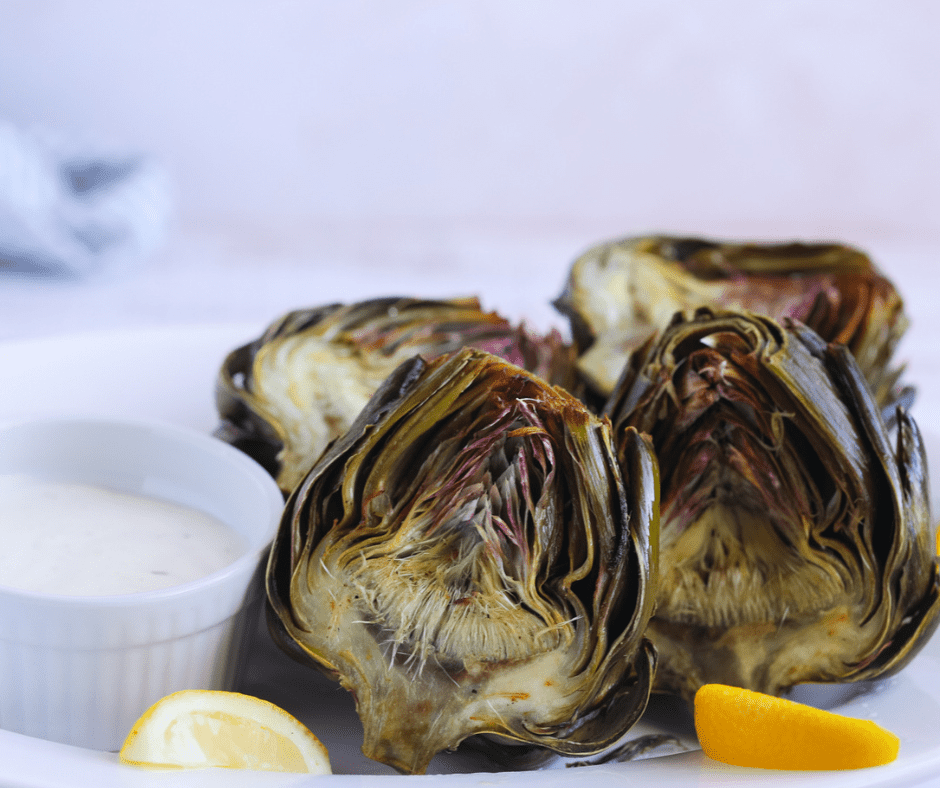 Golden crispy air fryer artichokes in the basket after cooking.