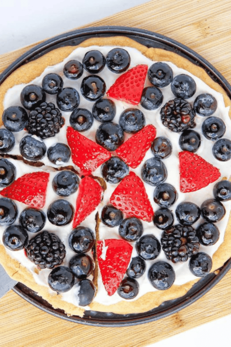 Air Fryer Sugar Fruit Pizza with colorful fresh fruit and creamy frosting on a golden sugar cookie base.