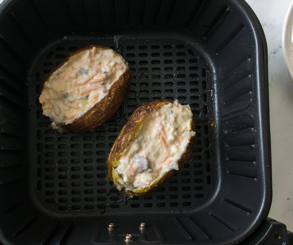 Twice baked potatoes in air fryer rack before cooking.