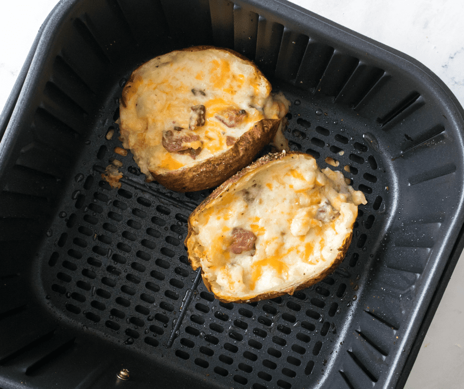 Twice baked potatoes in air fryer rack before cooking.