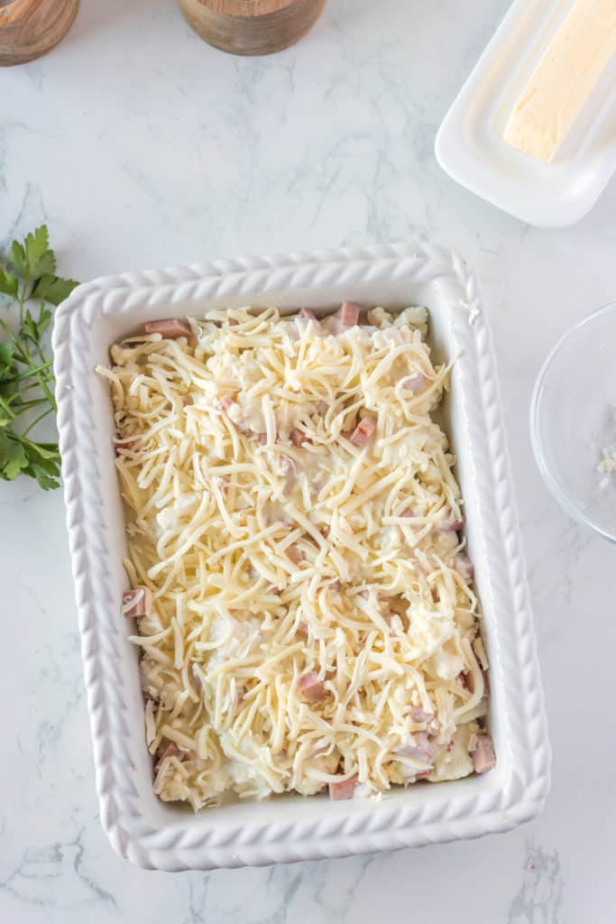 "Cauliflower cheese mixture placed in the air fryer basket, ready to cook."