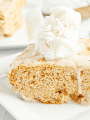 Close-up of Copycat Applebee’s Butter Pecan Blondies topped with pecan butter sauce and vanilla ice cream.