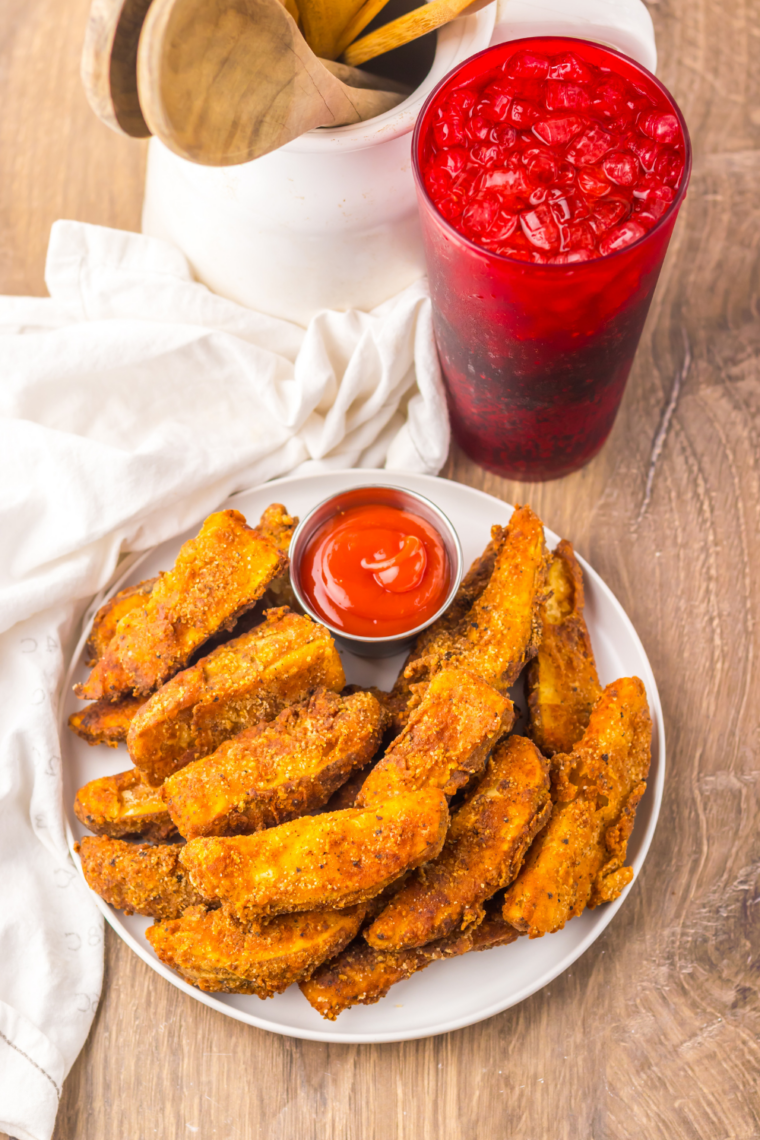 Close-up of crispy Popeyes-style Cajun battered fries sprinkled with Cajun seasoning