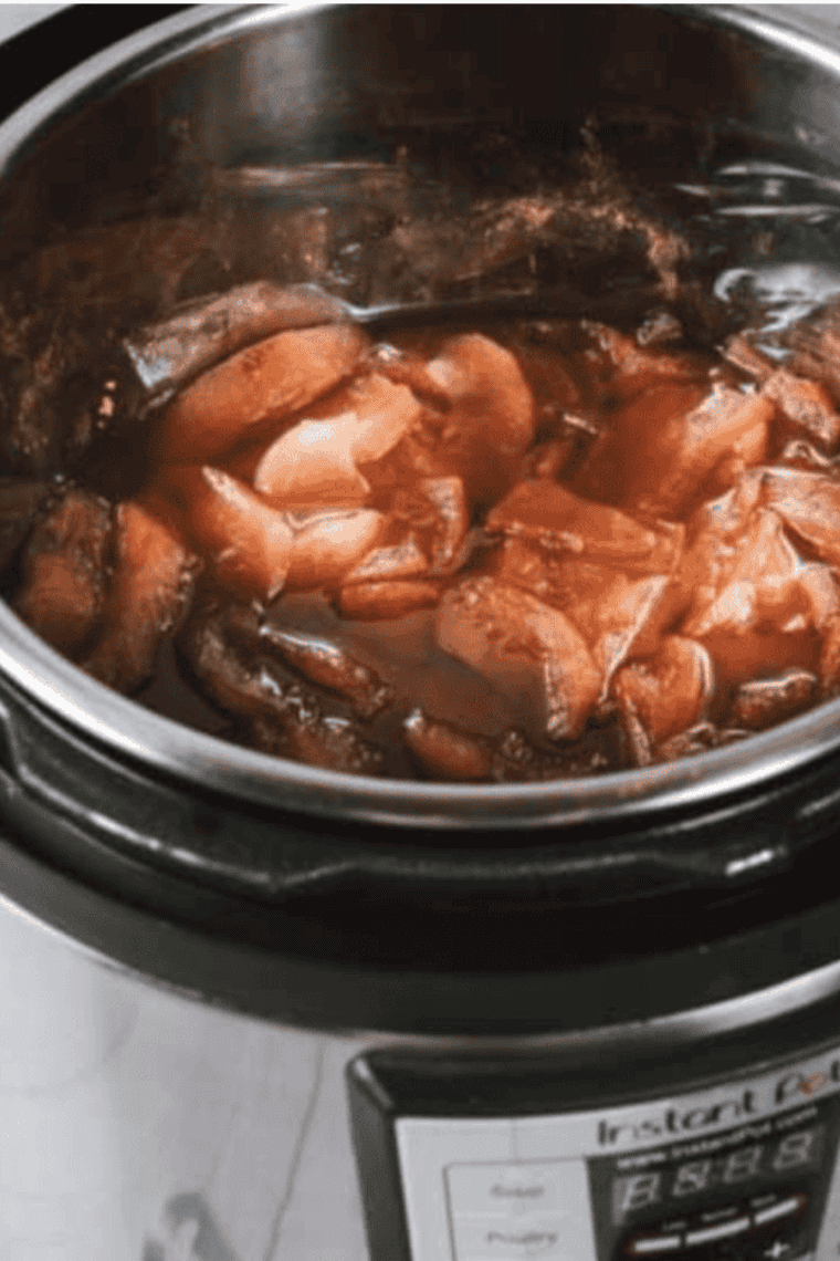 Carefully opening the pressure cooker, reducing excess liquid, and pureeing the apple mixture to a smooth, buttery consistency with an immersion blender.