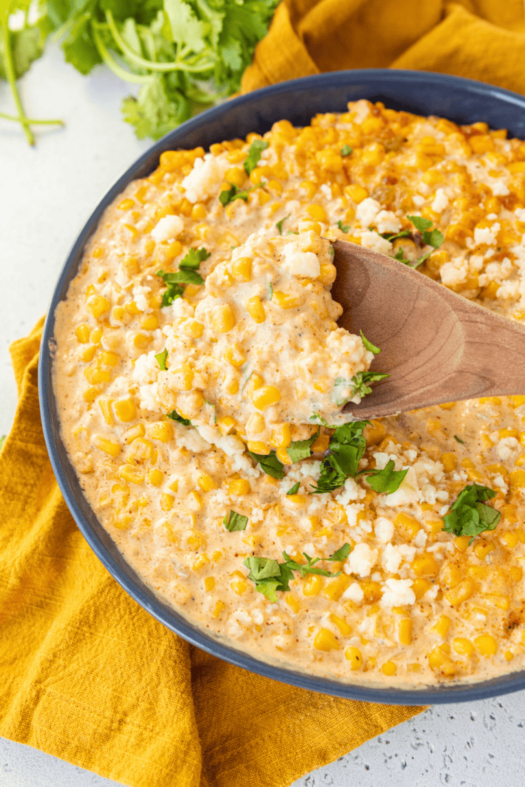 Creamy air fryer elote dip made with roasted corn, cheese, mayo, and spices served warm in a bowl with tortilla chips for dipping