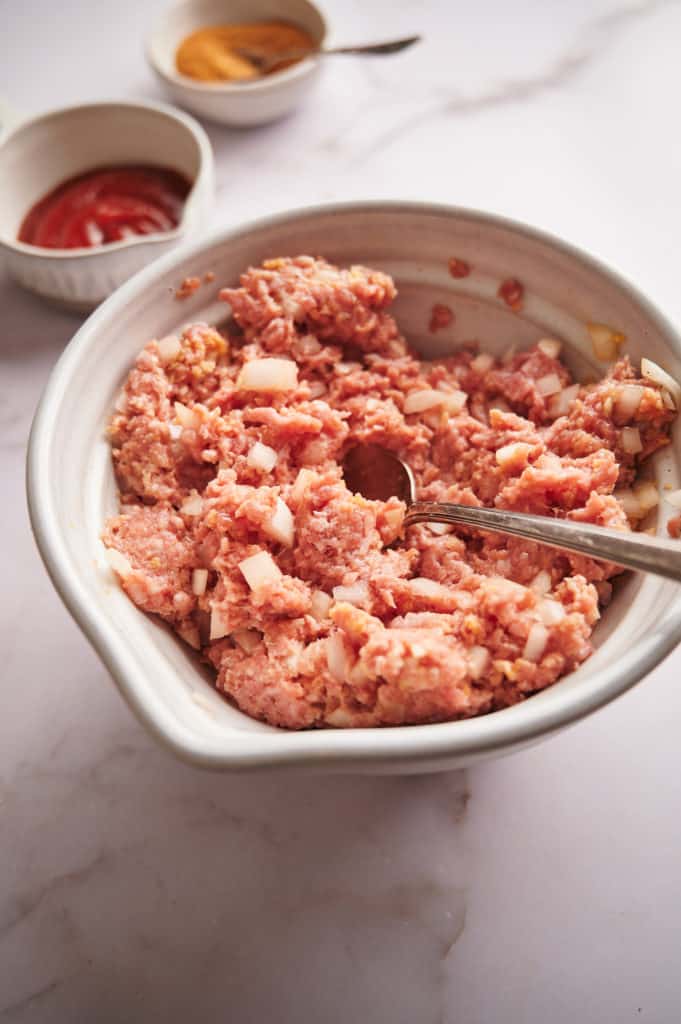 Meatloaf with Bourbon Glaze Mixture in a mixing bowl.