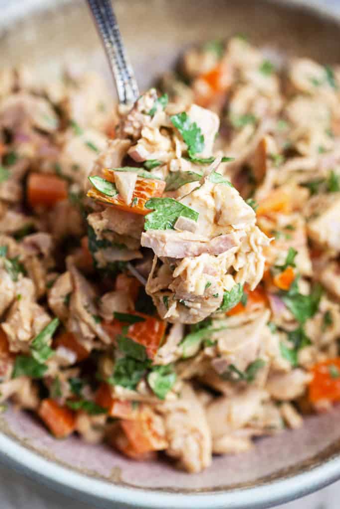 Garnished Air Fryer Southwestern Chicken Salad with cilantro and lime wedges."