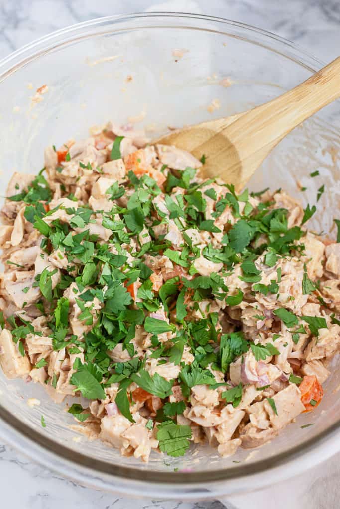 Zesty dressing being drizzled over the Air Fryer Southwestern Chicken Salad."