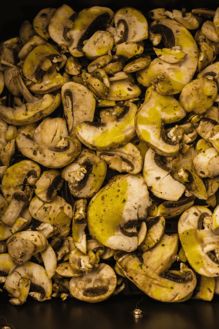 Preheat air fryer, coat mushrooms, and cook for 8-10 minutes.