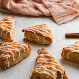 Overhead view of glazed air fryer apple scones with visible pieces of diced apple