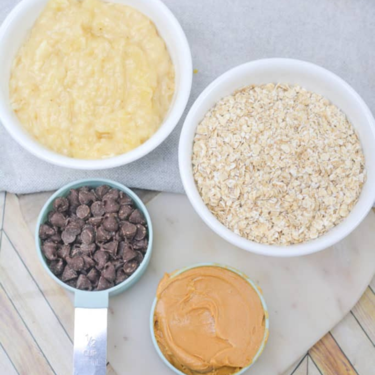 Ingredients for air fryer banana cookies — overripe bananas, old-fashioned oats, peanut butter, and chocolate chips