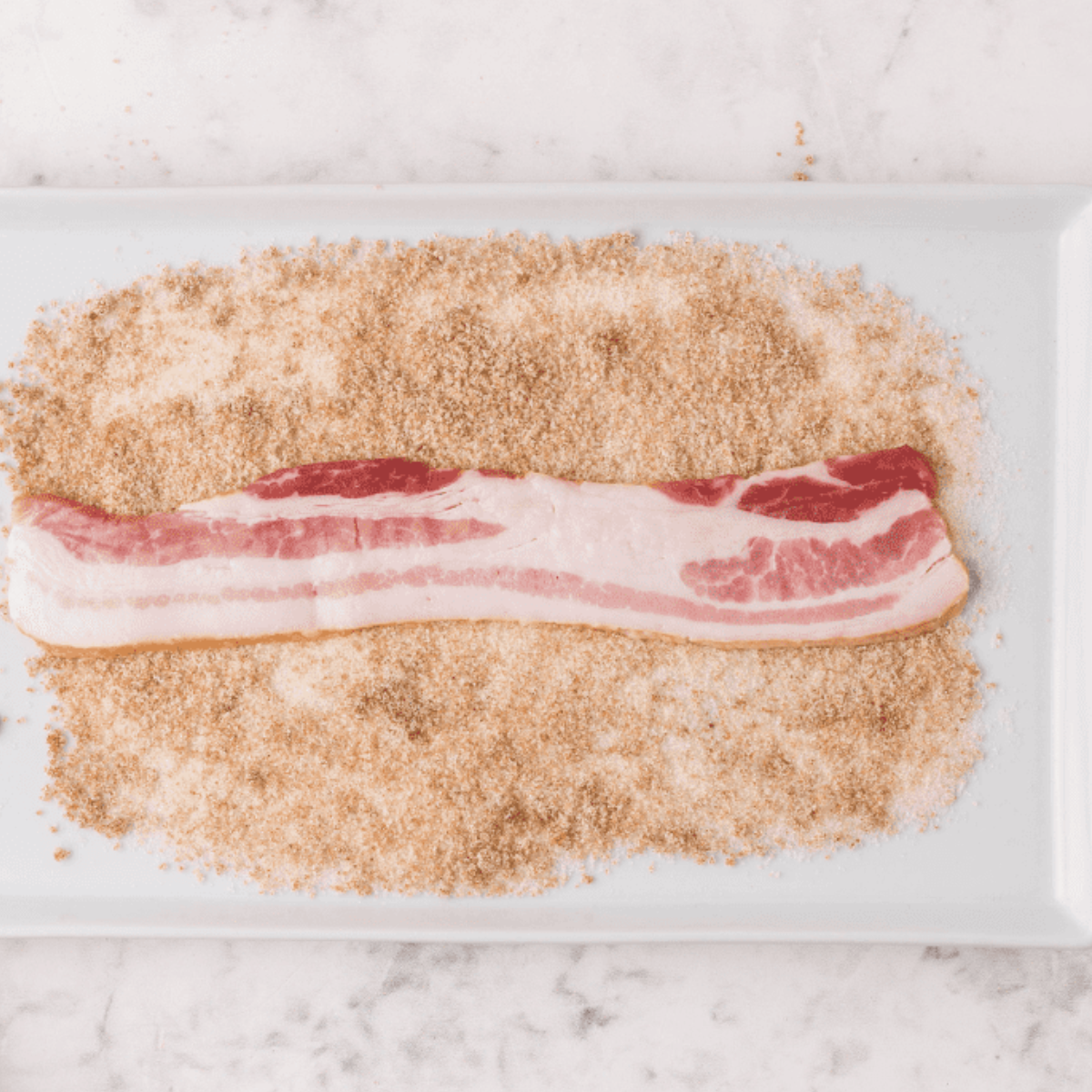 Diced bacon pieces in a bowl, prepared for air frying.