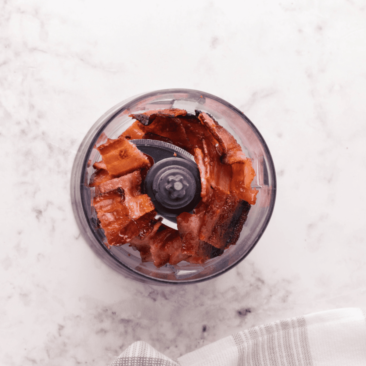 Crispy homemade bacon bits in a bowl, freshly cooked in the air fryer.
