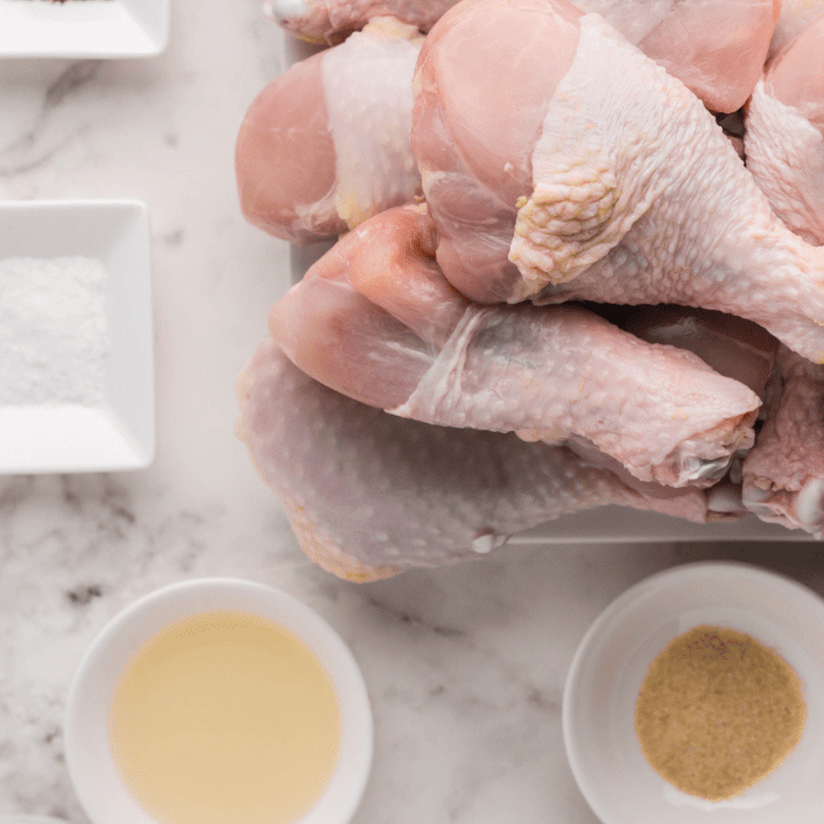 Raw chicken legs coated with honey mustard marinade.