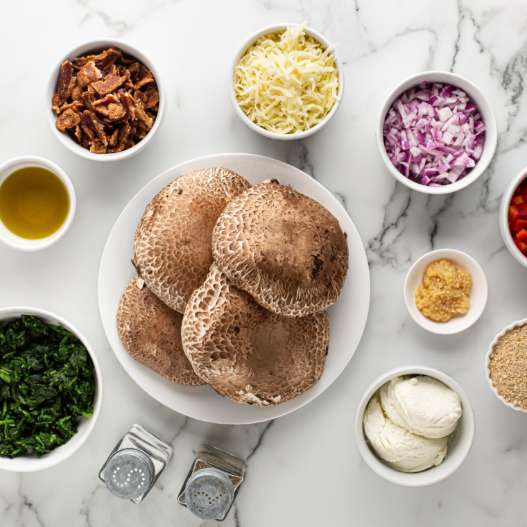 Ingredients needed for air fryer stuffed portobello mushrooms on kitchen table.