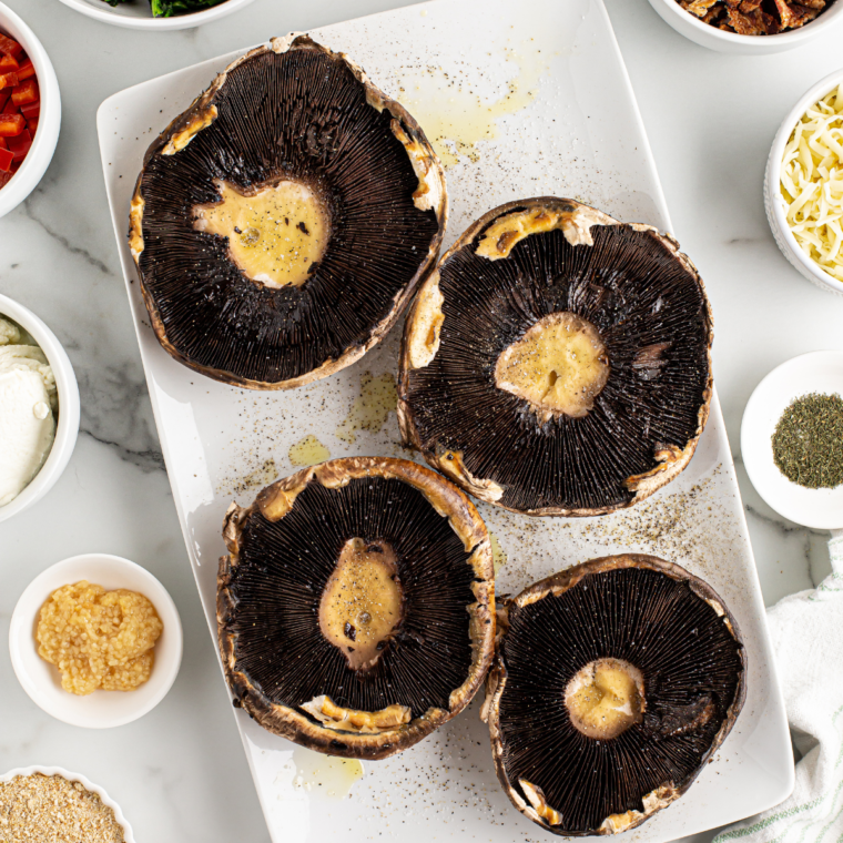 Clean portobello mushroom cap by wiping and removing stem.