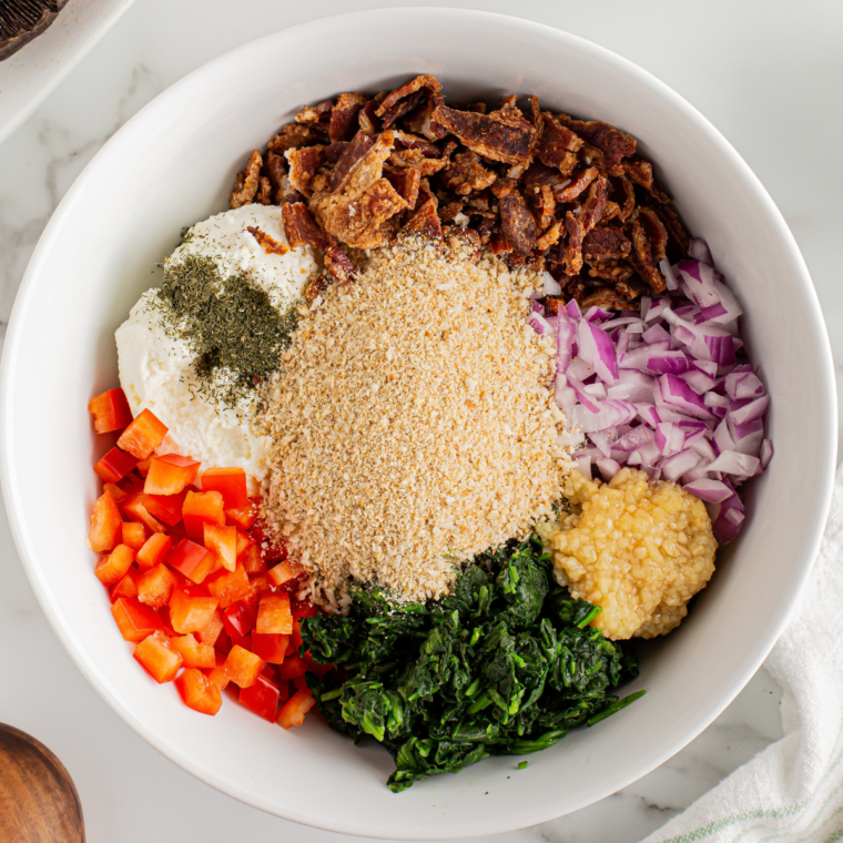 Combine ricotta cheese, bacon, spinach, and seasonings in bowl.