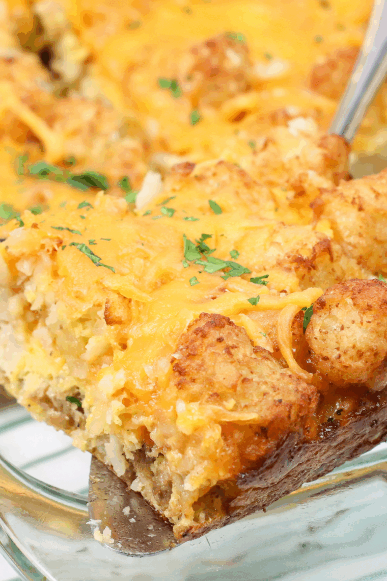 Close-up of air fryer tater tot breakfast casserole with crispy golden tots and bubbly melted cheese