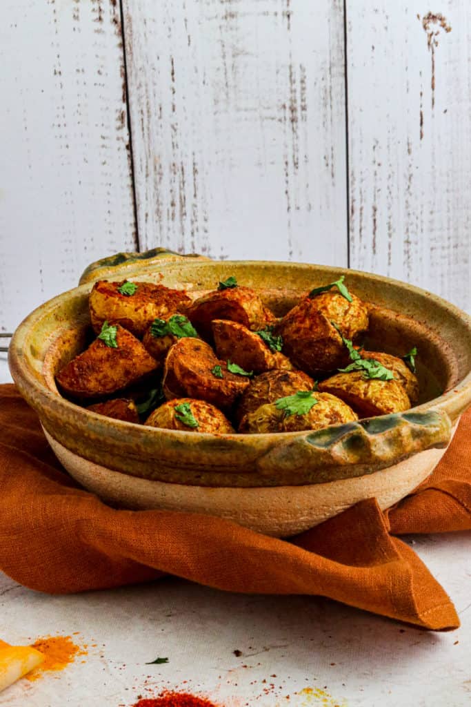 "Air Fryer Bombay Potatoes coated in Indian spices, crispy and golden brown"