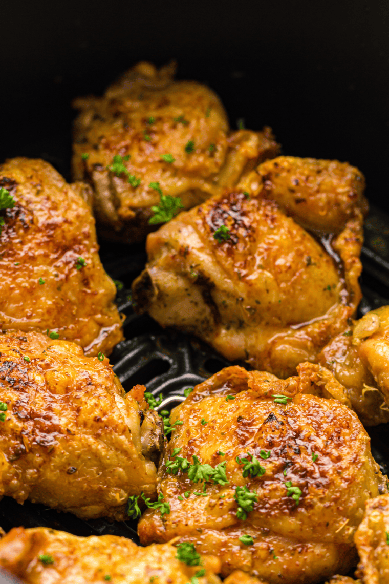 Close up of Chili Lime Chicken Thighs in the air fryer basket.