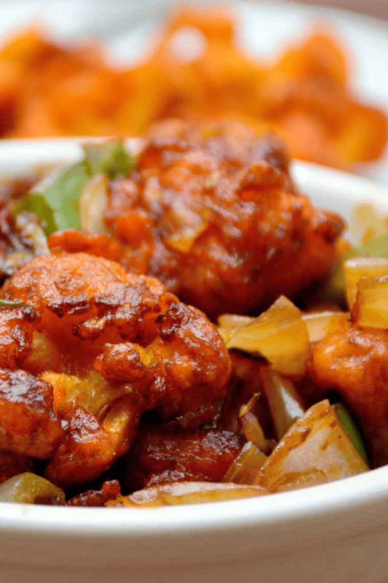 Golden air fryer cauliflower tossed in glossy teriyaki sauce, served hot.