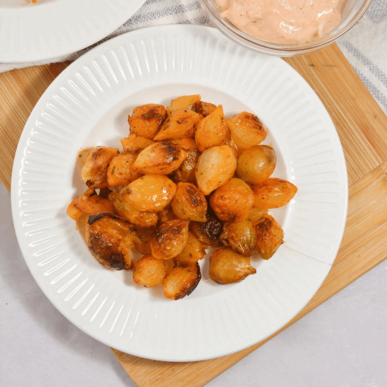 Golden brown air fried pearl onions in a bowl, crispy and perfectly roasted.