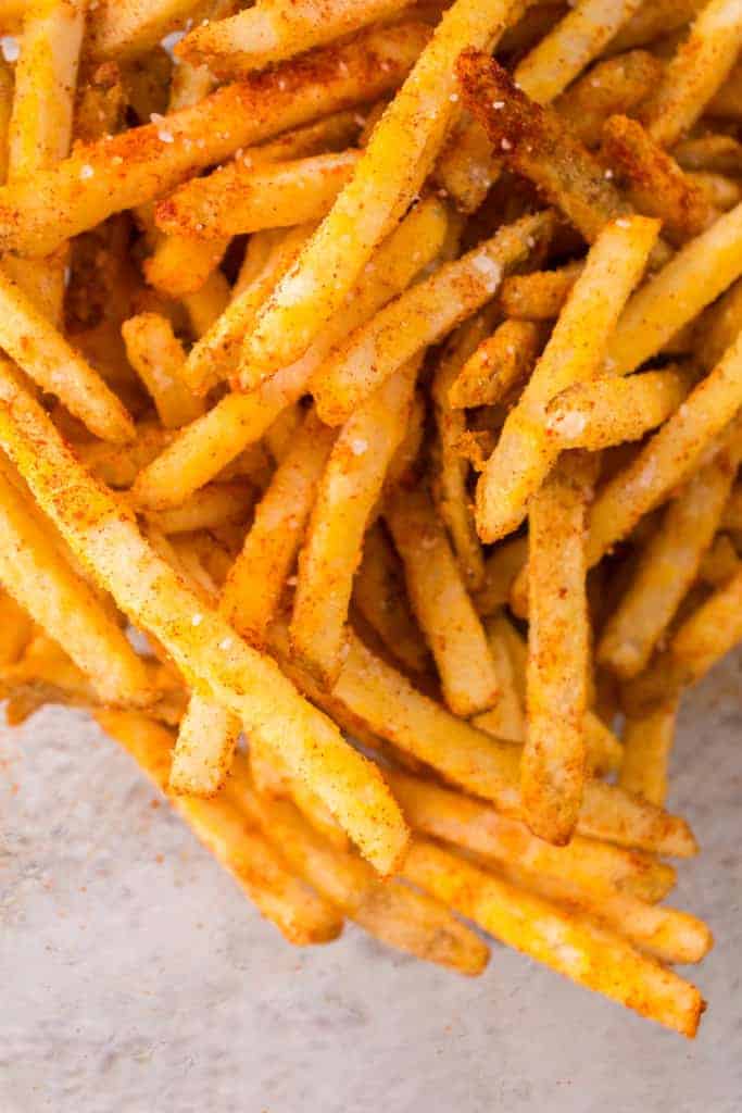 overhead closeup: air fryer checkers frozen fries with seasonings