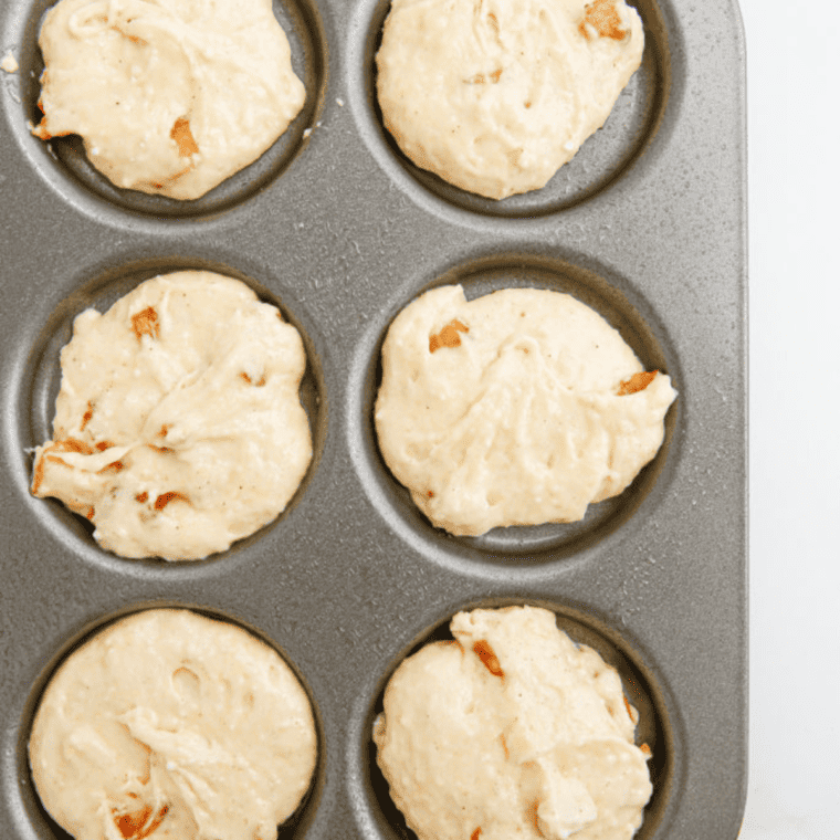 Scooping cake batter into whoopie pie cavities or onto parchment paper for air frying.