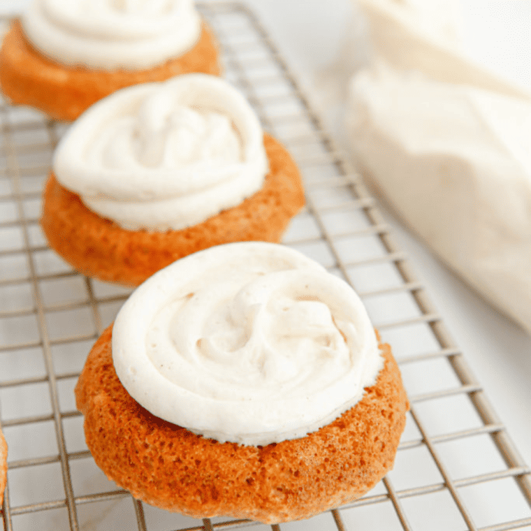 Air Fryer Apple Cinnamon Whoopie Pies stacked, showing soft cake layers filled with creamy cinnamon apple frosting.