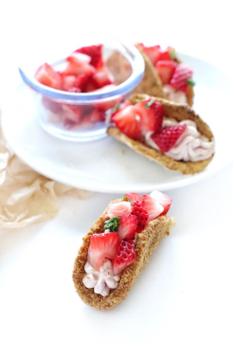 Air Fryer Cheesecake Strawberry Tacos with graham-coated shells and fresh diced strawberries