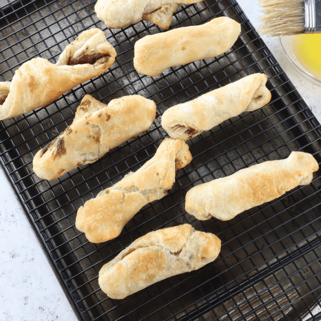 Coating hot air fryer churros in melted butter and rolling in cinnamon sugar mixture for finishing touch.