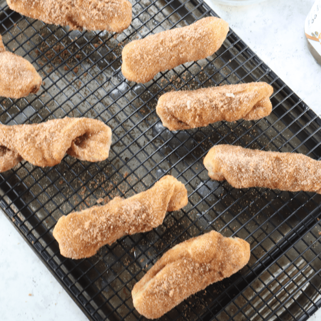Air fryer Nutella stuffed churros coated in cinnamon sugar on dessert plate