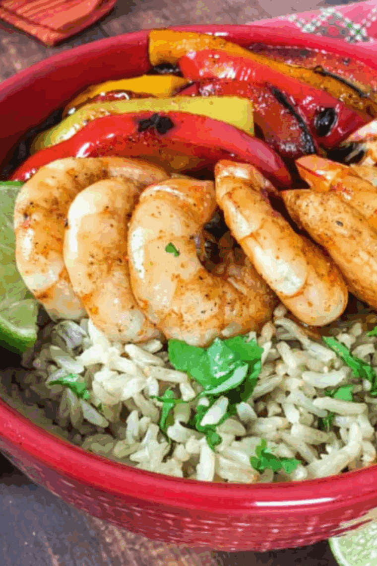 Overhead shot of a finished air fryer shrimp fajita bowl with toppings.
