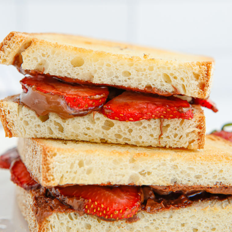 Assembled strawberry macadamia panini placed in the air fryer basket ready to cook