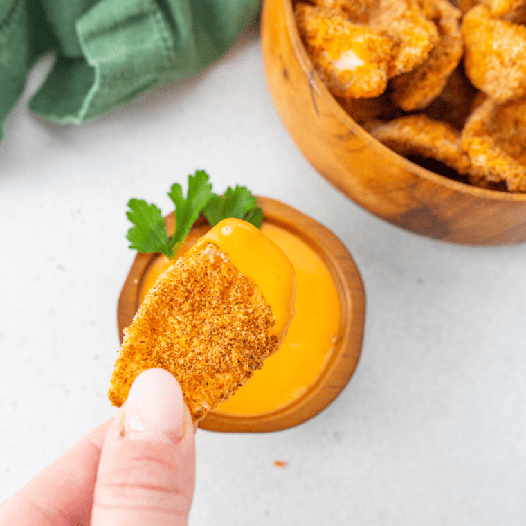 Golden crispy onion petals from Chili's Awesome Blossom Petals with dipping sauce on the side.