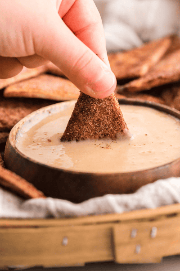 Picture of Churro Chips being dipped into the Cinnamon Salted Caramel Sauce.