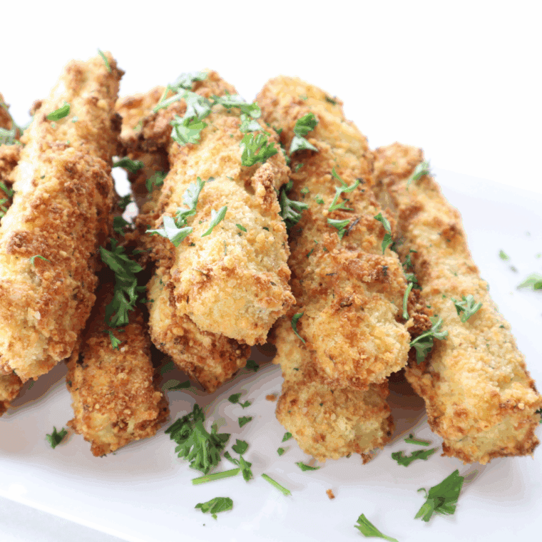 Golden, crispy air fryer eggplant fries on a plate with dipping sauce