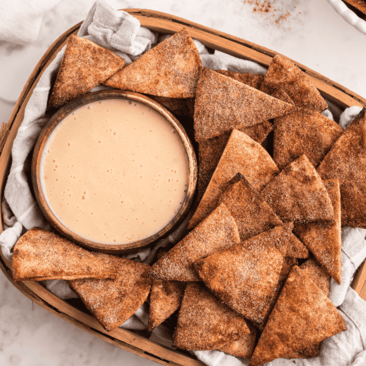Homemade Taco Bell Crispitos dusted with cinnamon sugar on a plate.