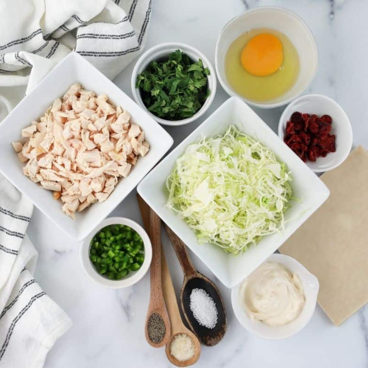 Ingredients needed for Air Fryer Chicken Cilantro Egg Rolls on kitchen table.