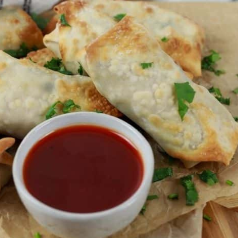 Golden, crispy Air Fryer Chicken Cilantro Egg Rolls filled with a savory chicken and cilantro mixture, ready to enjoy with your favorite dipping sauce.