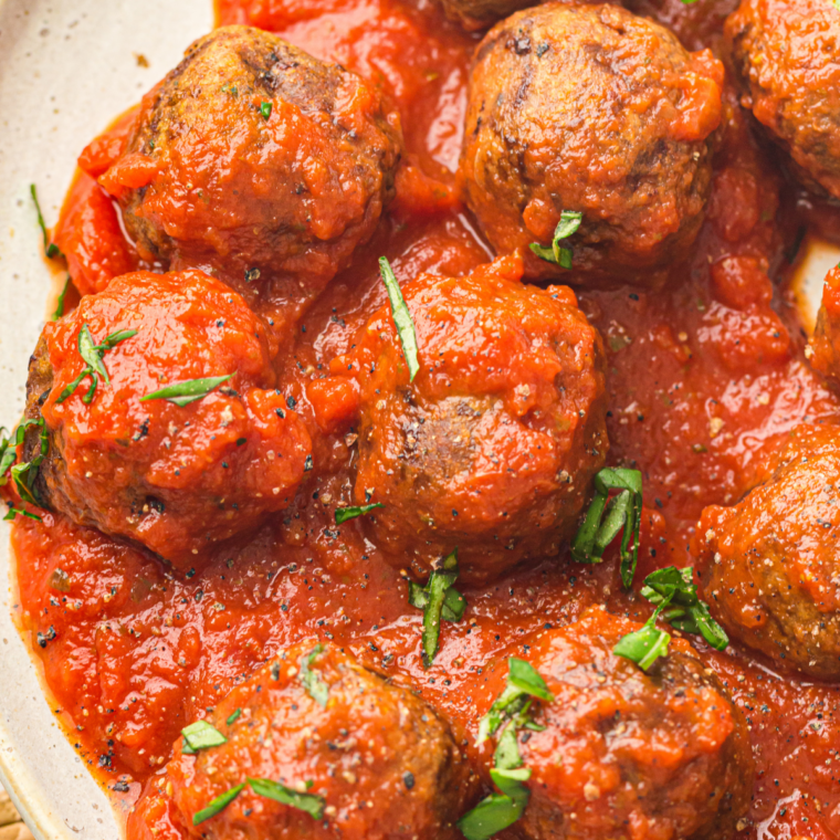 Air fryer chicken meatballs smothered in creamy brown gravy and topped with fresh parsley