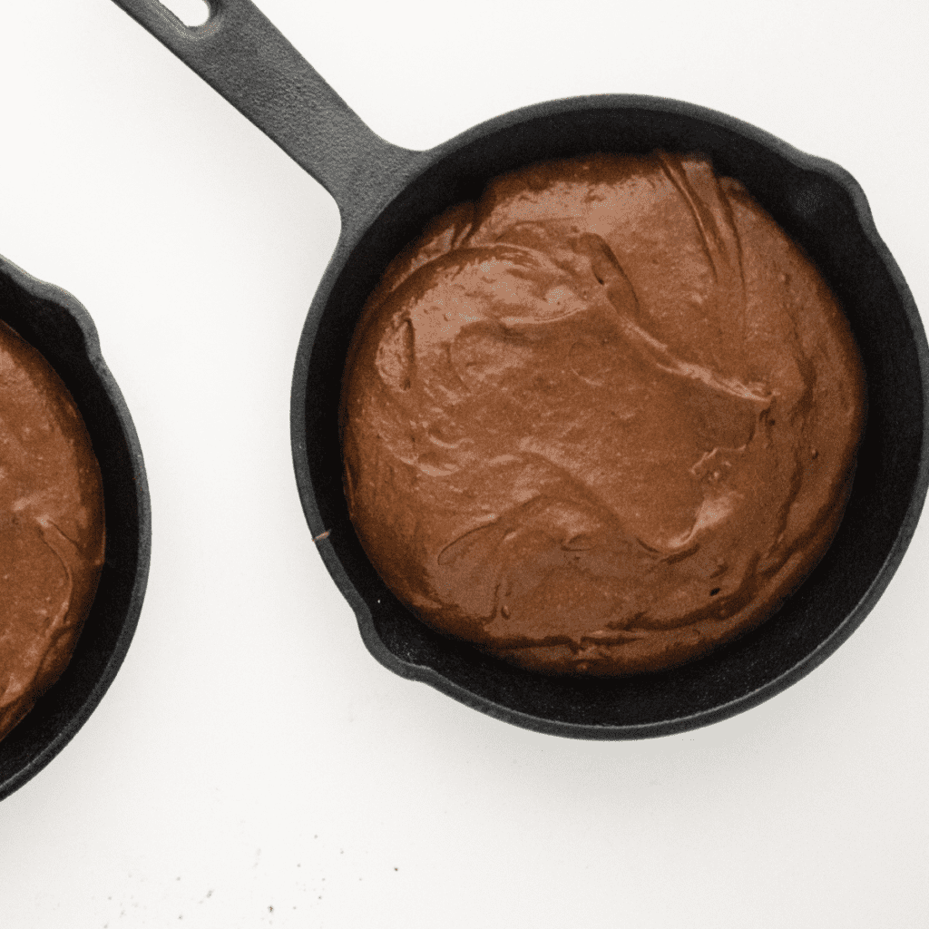 Brownie batter in a pan placed inside the air fryer basket