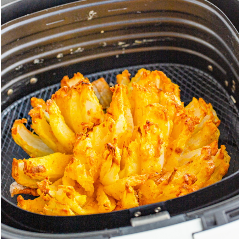 Air fryer copycat Outback Steakhouse bloomin' onion, golden and crispy with petals fanned open, served with dipping sauce