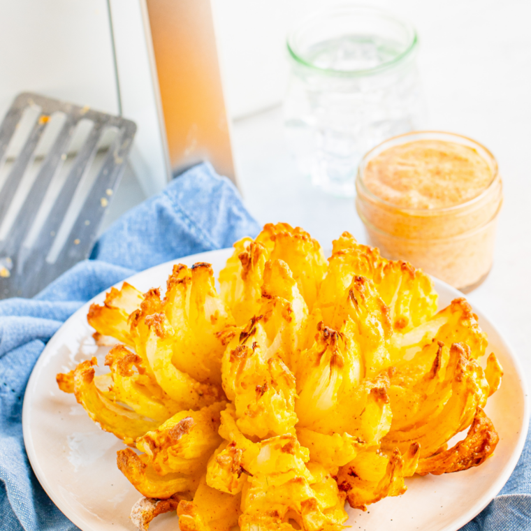 Crispy air fryer bloomin' onion, a copycat Outback Steakhouse appetizer, with creamy dipping sauce