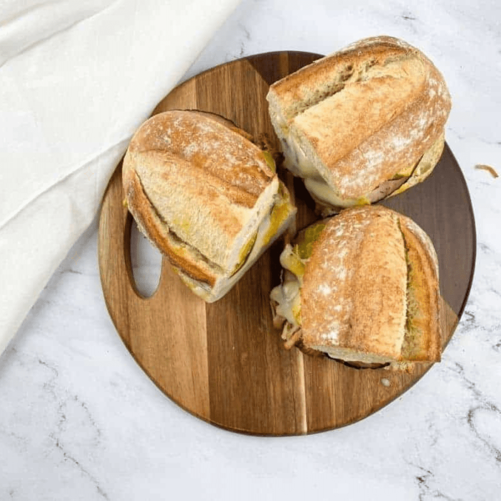 "Close-up of a delicious Air Fryer Cuban Sandwich with layers of ham, roast pork, and Swiss cheese."