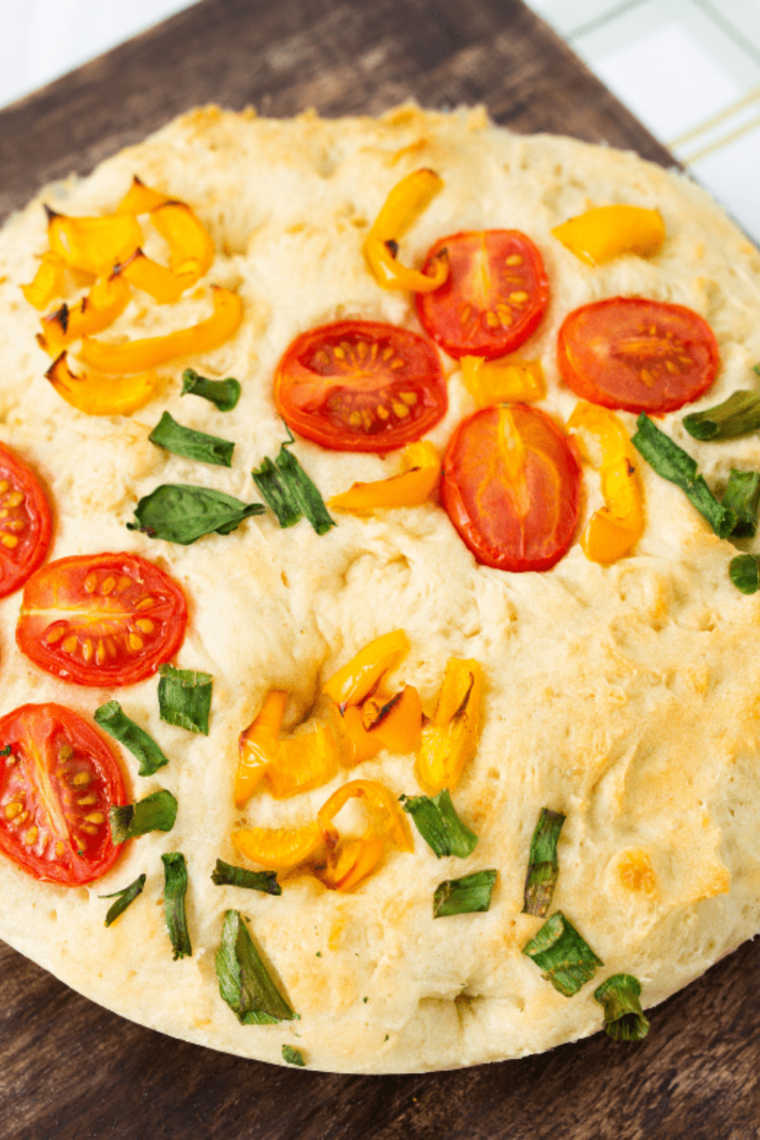 Air fryer garden focaccia with golden crust, fresh herbs, and cherry tomatoes