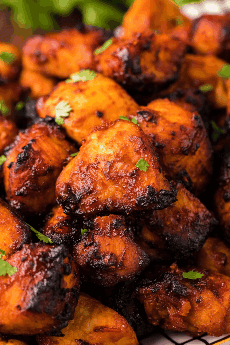 Golden Air Fryer Guava Chicken glazed with sweet and tangy tropical sauce, garnished with fresh herbs