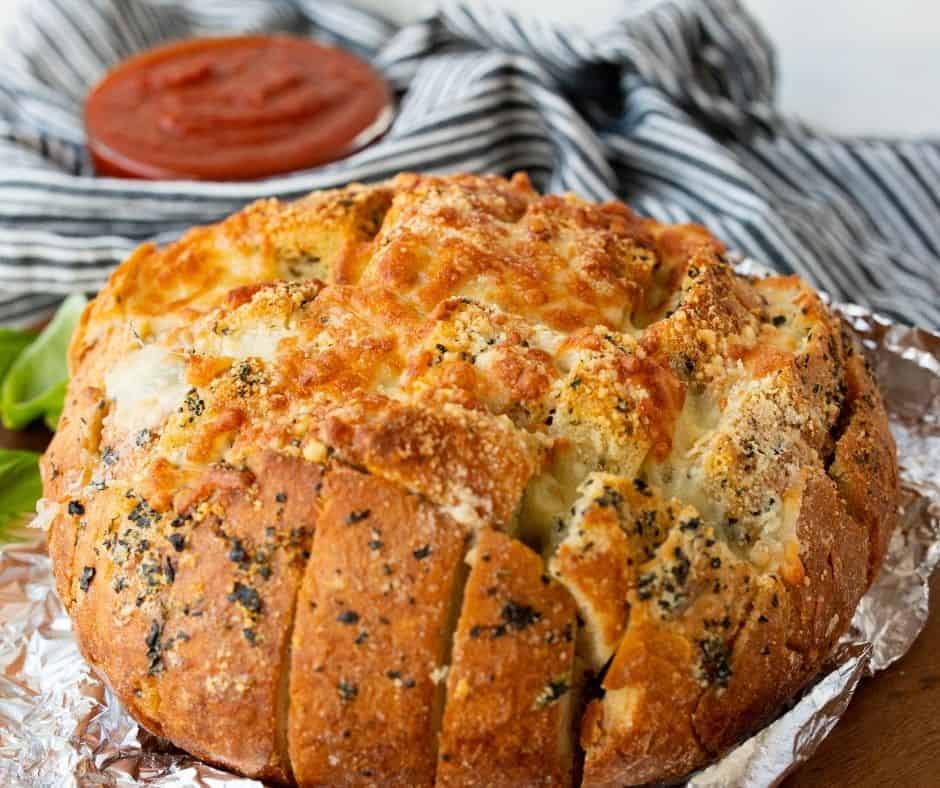 Cheesy, golden air fryer crack bread, sliced and ready to serve as a savory appetizer or snack.