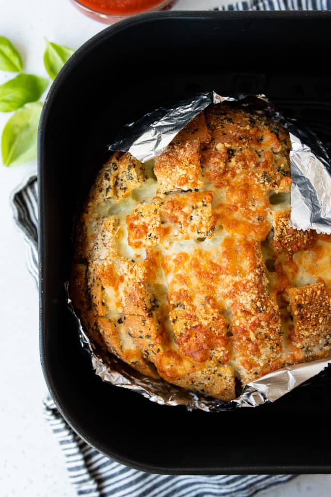 Golden and cheesy air fryer crack bread, sliced and ready to serve as a savory snack or appetizer.